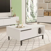 Table basse Vega blanche avec pieds en acier noir dans un salon moderne